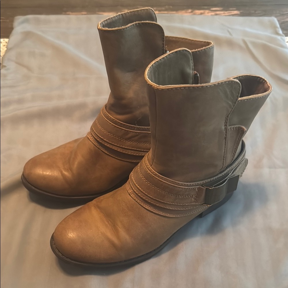 Brown leather boots with unique buckle